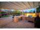 Entertain guests at this outdoor kitchen featuring a large island and built in appliances at 29991 N 78Th Pl, Scottsdale, AZ 85266