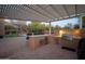 Outdoor kitchen with pergola, granite countertop, and grill at 29991 N 78Th Pl, Scottsdale, AZ 85266