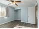 Light blue bedroom with wood-look floors and closet at 3433 E Paradise Dr, Phoenix, AZ 85028