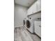 Laundry room with washer, dryer, and granite countertop at 371 N 157Th Ln, Goodyear, AZ 85338