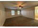 Spacious bedroom with carpet flooring, built-in shelving, and ceiling fan at 4073 E Vaughn Ave, Gilbert, AZ 85234