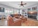 Spacious living room with leather sectional sofa, built-in shelving, and large TV at 40916 N Harbour Town Way, New River, AZ 85087