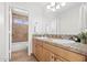 Double vanity bathroom with granite countertop and tiled shower at 4421 E Meadow Dr, Phoenix, AZ 85032