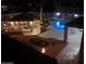 Night view of a backyard with a pool and covered patio at 4530 W Misty Willow Ln, Glendale, AZ 85310