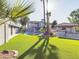 Spacious backyard with lush lawn, pool, and outdoor kitchen at 4530 W Misty Willow Ln, Glendale, AZ 85310