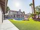 Two story home with pool, putting green and grassy backyard at 4530 W Misty Willow Ln, Glendale, AZ 85310