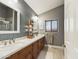 Modern bathroom with double vanity and gray tile at 4530 W Misty Willow Ln, Glendale, AZ 85310