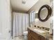 Updated bathroom with granite vanity and large mirror at 4530 W Misty Willow Ln, Glendale, AZ 85310