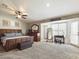 Bright bedroom with large window and ceiling fan at 4530 W Misty Willow Ln, Glendale, AZ 85310