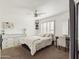 Light and airy bedroom with a queen bed and built-in desk at 4530 W Misty Willow Ln, Glendale, AZ 85310