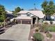 Two-story home with stone accents, three-car garage, and basketball hoop at 4530 W Misty Willow Ln, Glendale, AZ 85310