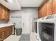 Laundry room with washer, dryer, cabinets, and ample counter space at 4530 W Misty Willow Ln, Glendale, AZ 85310