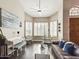 Spacious living room with bay windows, hardwood floors, and comfortable seating at 4530 W Misty Willow Ln, Glendale, AZ 85310