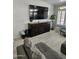 Living room with large TV and wood media console at 4530 W Misty Willow Ln, Glendale, AZ 85310