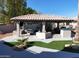 Covered patio with outdoor kitchen, seating area, and fire pit at 4530 W Misty Willow Ln, Glendale, AZ 85310