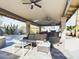 Covered patio with comfortable seating and outdoor fireplace at 4530 W Misty Willow Ln, Glendale, AZ 85310