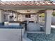 Outdoor kitchen and dining area under a covered patio at 4530 W Misty Willow Ln, Glendale, AZ 85310