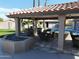Outdoor kitchen and dining area under a covered patio at 4530 W Misty Willow Ln, Glendale, AZ 85310