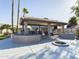 Covered patio with outdoor kitchen and fire pit at 4530 W Misty Willow Ln, Glendale, AZ 85310