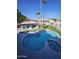 Aerial view of freeform pool and spa with swim-up bar and patio at 4530 W Misty Willow Ln, Glendale, AZ 85310