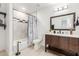 Bathroom with a modern vanity, tiled shower, and neutral color scheme at 4602 N 47Th Ave, Phoenix, AZ 85031