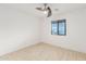 Bright bedroom features tile floors, a modern ceiling fan, and window with natural light at 4602 N 47Th Ave, Phoenix, AZ 85031