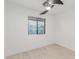 Bright bedroom features tile floors, a modern ceiling fan, and window with natural light at 4602 N 47Th Ave, Phoenix, AZ 85031