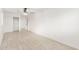 Large bedroom with wood-look tile flooring, and access to closet and hallway at 4602 N 47Th Ave, Phoenix, AZ 85031