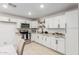 Contemporary kitchen featuring white cabinetry, granite countertops, and modern appliances at 4602 N 47Th Ave, Phoenix, AZ 85031