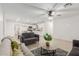 Bright open-concept space featuring tile floors and a view into the kitchen at 4602 N 47Th Ave, Phoenix, AZ 85031