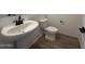 Well-lit bathroom featuring a white sink, black faucet, and modern fixtures at 47250 W Mellen Ln, Maricopa, AZ 85139