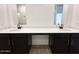 Dual vanity in a bathroom featuring dark wood cabinets and modern fixtures at 47250 W Mellen Ln, Maricopa, AZ 85139