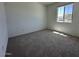 Bright bedroom featuring plush carpeting and a window letting in ample natural light at 47250 W Mellen Ln, Maricopa, AZ 85139