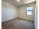 Cozy bedroom featuring neutral carpet, bright natural light, and electrical outlets at 47250 W Mellen Ln, Maricopa, AZ 85139