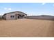 Backyard with partial dirt and block wall around the perimeter of the yard and house at 4816 N 177Th Ln, Goodyear, AZ 85395