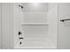 Clean, white bathroom features a shower-tub combination, subway tile surround, and sleek black fixtures at 4816 N 177Th Ln, Goodyear, AZ 85395
