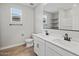 Bathroom features double sinks, white cabinets, modern fixtures, tile floors, and natural light at 4816 N 177Th Ln, Goodyear, AZ 85395