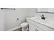 Bathroom features a white vanity, dual sinks, modern fixtures, and a convenient toilet paper holder at 4816 N 177Th Ln, Goodyear, AZ 85395