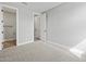 Bright bedroom with plush carpeting, showing an open doorway to an adjacent bathroom with tile flooring at 4816 N 177Th Ln, Goodyear, AZ 85395