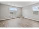 Comfortable bedroom with wood-look tile floors, natural light, and neutral paint at 4816 N 177Th Ln, Goodyear, AZ 85395