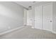 Bright bedroom featuring carpeted flooring with a view of the closet and hall at 4816 N 177Th Ln, Goodyear, AZ 85395