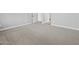 Spacious bedroom with neutral walls, plush carpet, white baseboards, and a large doorway at 4816 N 177Th Ln, Goodyear, AZ 85395