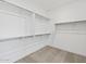 Spacious walk-in closet features adjustable shelving and ample storage space, with neutral carpeting and bright lighting at 4816 N 177Th Ln, Goodyear, AZ 85395