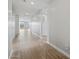 Bright hallway with wood-look floors leading to an open living space and backyard access at 4816 N 177Th Ln, Goodyear, AZ 85395