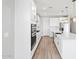 Modern kitchen features stainless appliances, white cabinets, hardwood floors, and a spacious center island with sink at 4816 N 177Th Ln, Goodyear, AZ 85395
