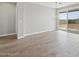 Bright living room with wood-look flooring, chandelier, and sliding glass doors to the backyard at 4816 N 177Th Ln, Goodyear, AZ 85395