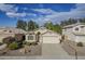 Single-story home with a two-car garage and well-manicured landscaping at 5058 E Harmony Ave, Mesa, AZ 85206