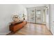 Light and bright entryway with hardwood floors and mid-century modern console table at 639 E Calavar Rd, Phoenix, AZ 85022