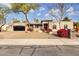 Beautiful Spanish style home with landscaped front yard and a three-car garage at 7618 E Ironwood Dr, Scottsdale, AZ 85258