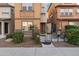 Three-story townhome with private patio and well-manicured landscaping at 7771 W Pipestone Pl, Phoenix, AZ 85035